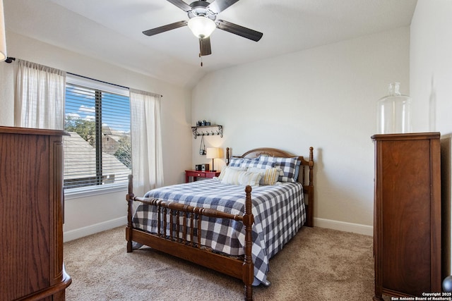 bedroom with ceiling fan, lofted ceiling, and light carpet