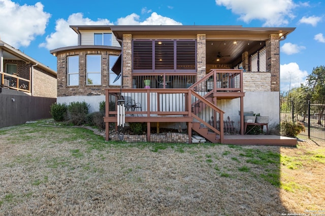 back of house featuring ceiling fan, a yard, and a deck