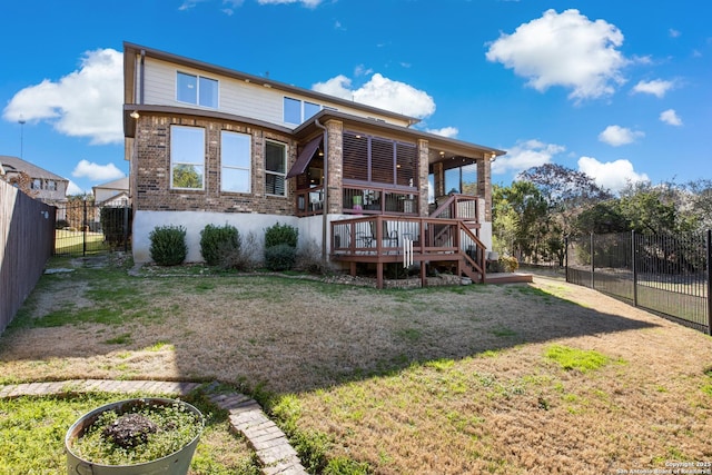 back of house featuring a yard and a deck