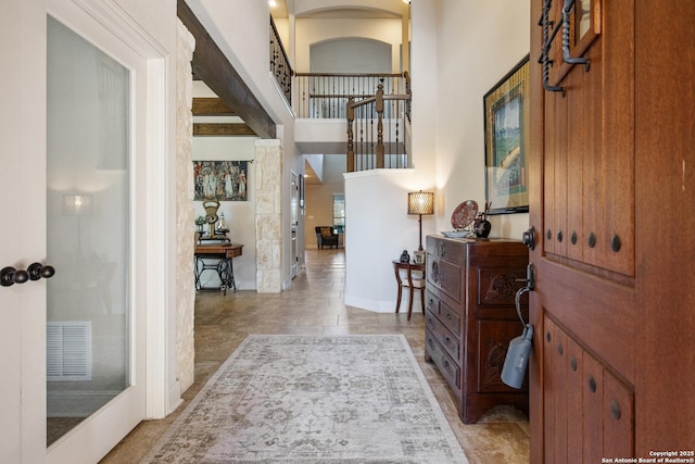 foyer entrance featuring a towering ceiling