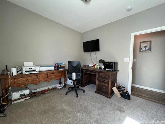 office area featuring lofted ceiling and carpet