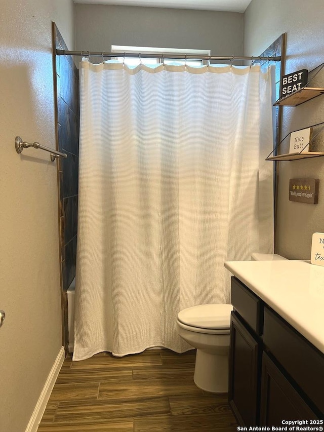 full bathroom with shower / bathtub combination with curtain, vanity, toilet, and hardwood / wood-style floors