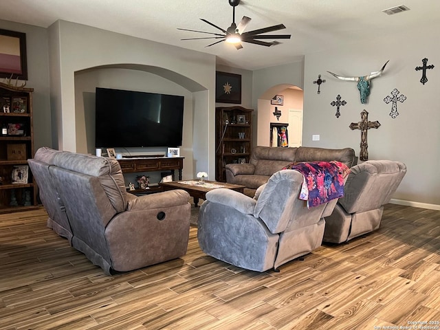 living room featuring lofted ceiling, hardwood / wood-style floors, and ceiling fan