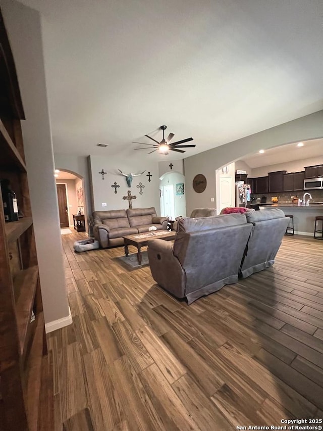 living room with hardwood / wood-style flooring and ceiling fan