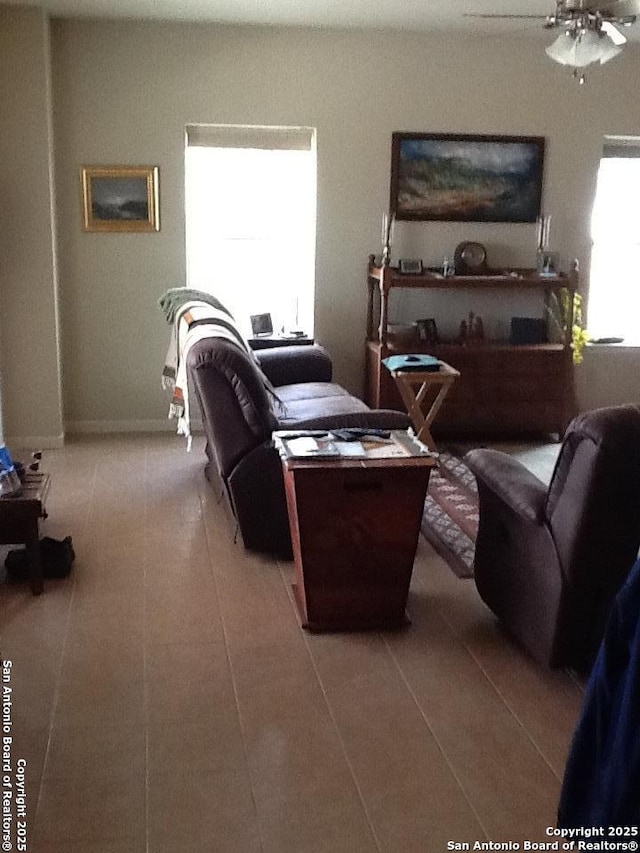 living room featuring tile patterned floors and ceiling fan