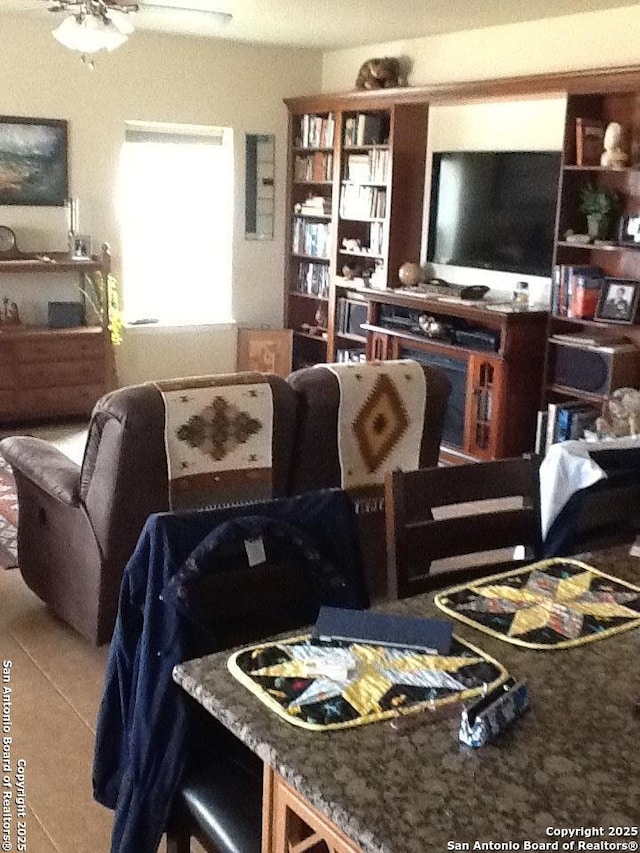 tiled dining room featuring ceiling fan