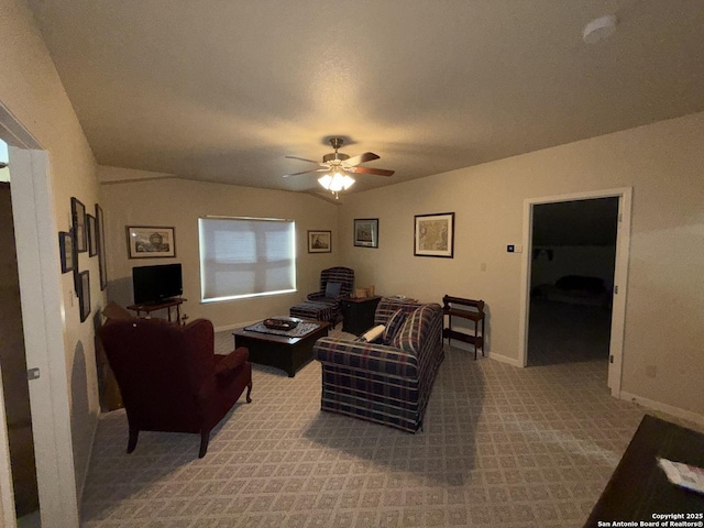 carpeted living room with ceiling fan and lofted ceiling