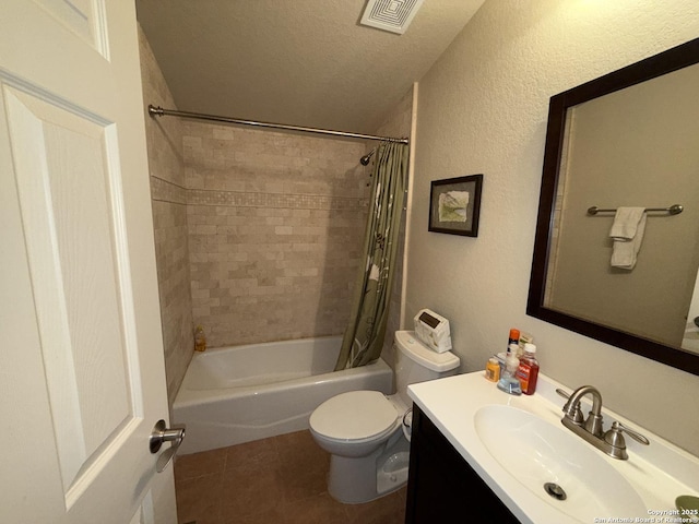 full bathroom with shower / tub combo with curtain, tile patterned flooring, vanity, toilet, and a textured ceiling