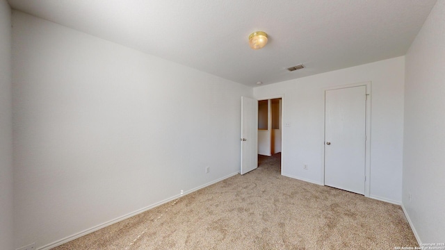 unfurnished bedroom featuring light carpet