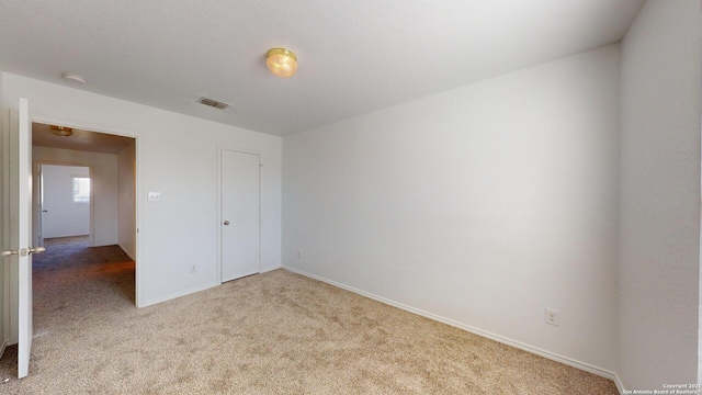 unfurnished bedroom featuring light carpet