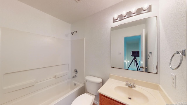 full bathroom featuring vanity, bathing tub / shower combination, and toilet