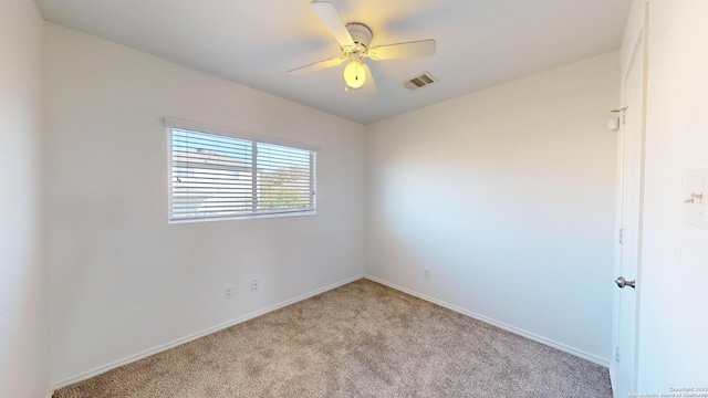 empty room featuring light carpet and ceiling fan