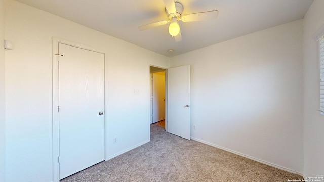 unfurnished bedroom featuring ceiling fan and light carpet