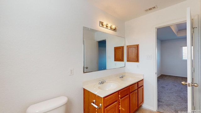 bathroom with vanity and toilet