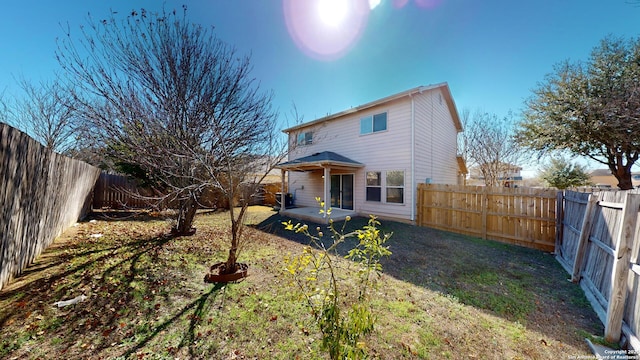 rear view of house featuring a lawn