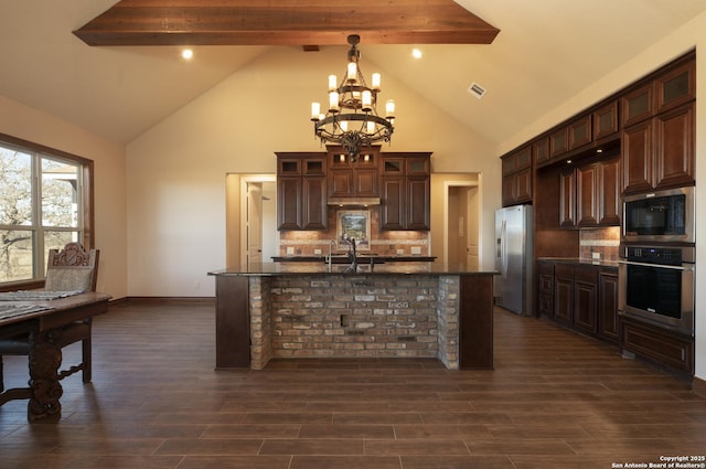 kitchen with stainless steel appliances, visible vents, dark wood-type flooring, and an inviting chandelier