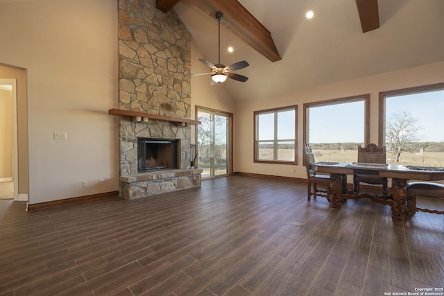 living room featuring a stone fireplace, high vaulted ceiling, dark hardwood / wood-style flooring, ceiling fan, and beam ceiling