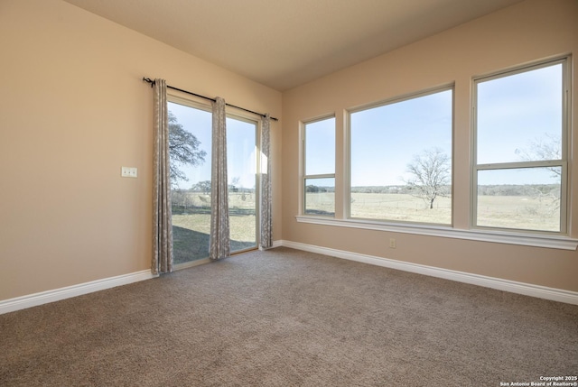 unfurnished room with carpet and baseboards