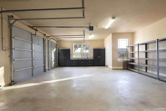 garage with a garage door opener and baseboards