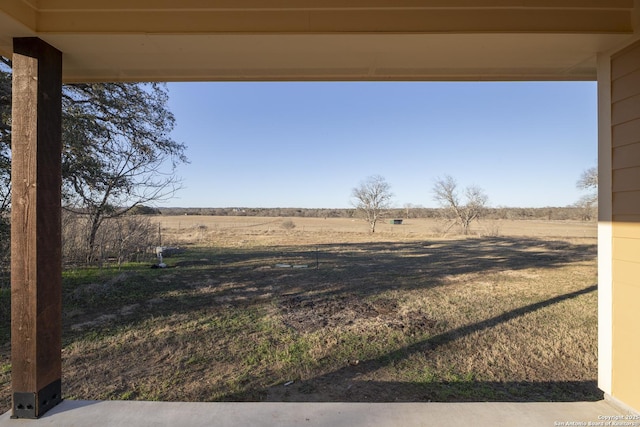 view of yard with a rural view