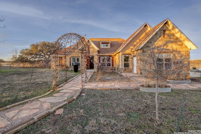 rear view of house with stone siding