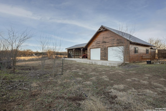 view of property exterior with an outbuilding and a garage