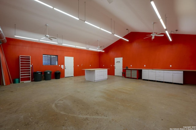 garage featuring a ceiling fan and a workshop area