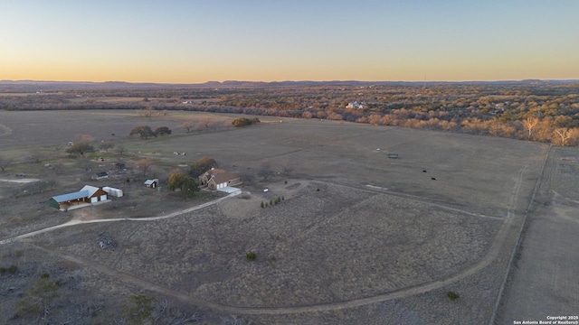 aerial view at dusk featuring a rural view