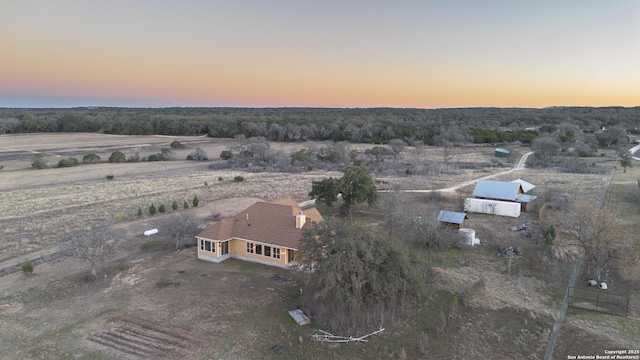 aerial view at dusk featuring a rural view