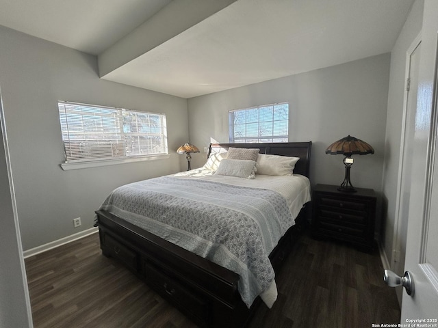 bedroom with dark hardwood / wood-style flooring and multiple windows