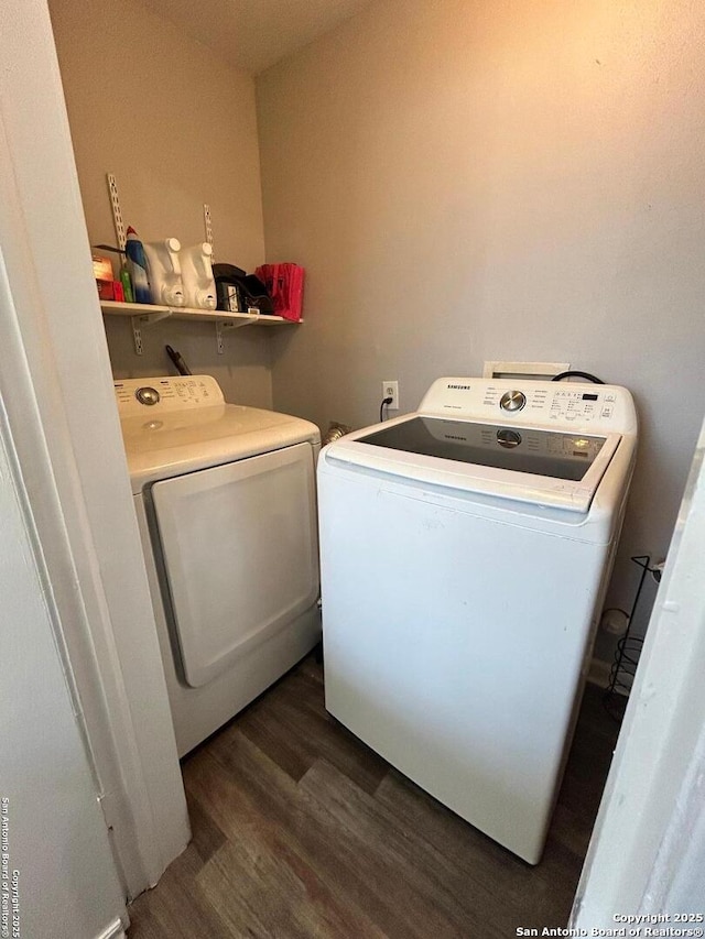 laundry area featuring washer and dryer and dark hardwood / wood-style floors