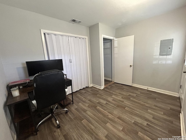 home office with dark wood-type flooring