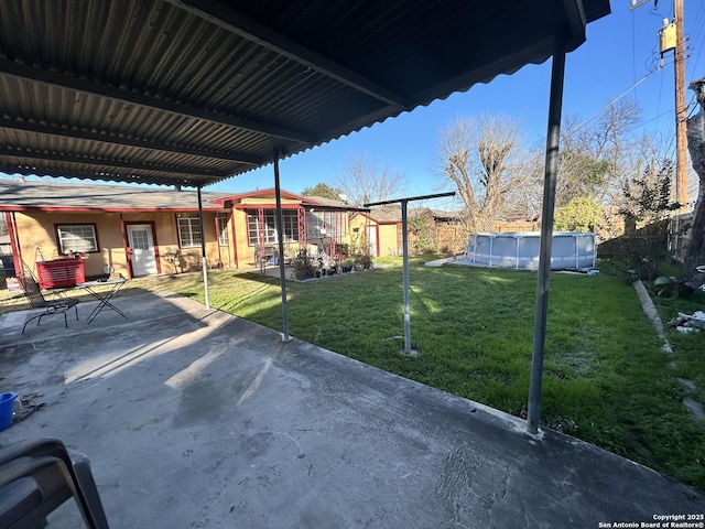 view of yard with a fenced in pool and a patio area