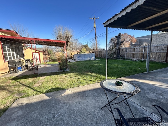 view of yard with a shed, a fenced in pool, and a patio