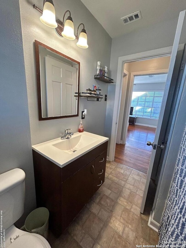 bathroom featuring vanity and toilet