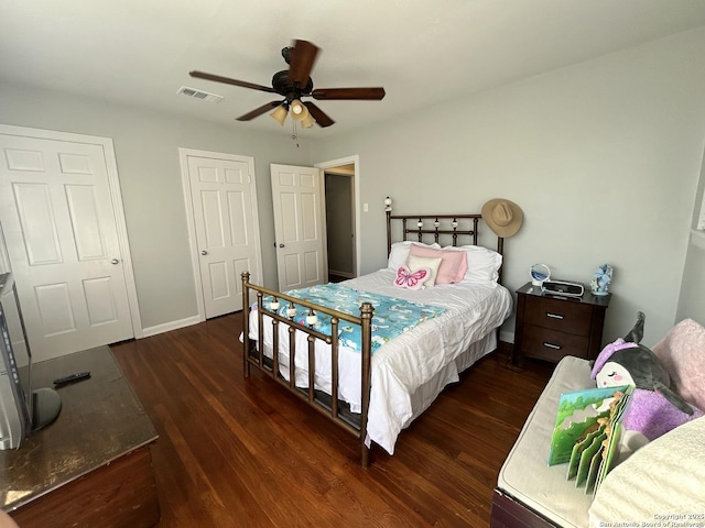 bedroom with ceiling fan and dark hardwood / wood-style flooring