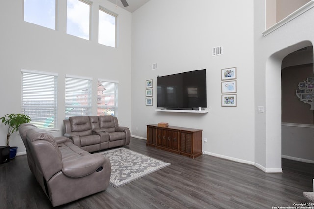 living room with ceiling fan and dark hardwood / wood-style flooring