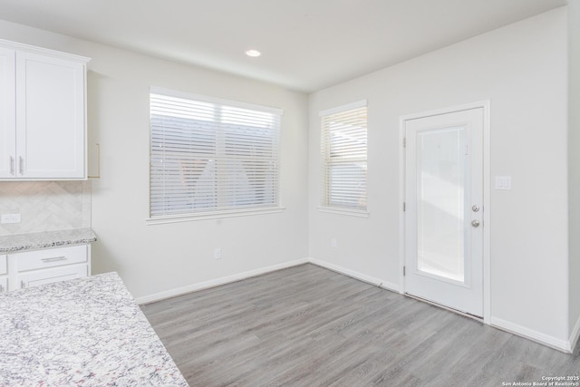 unfurnished dining area featuring light hardwood / wood-style flooring