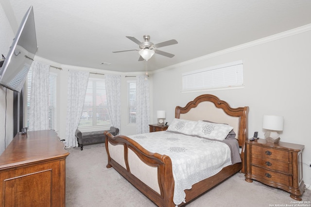 bedroom with light carpet, crown molding, and ceiling fan