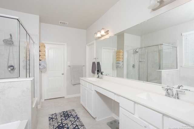 bathroom with an enclosed shower, vanity, and tile patterned floors