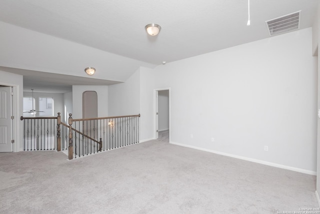 spare room featuring vaulted ceiling, ceiling fan, and carpet floors