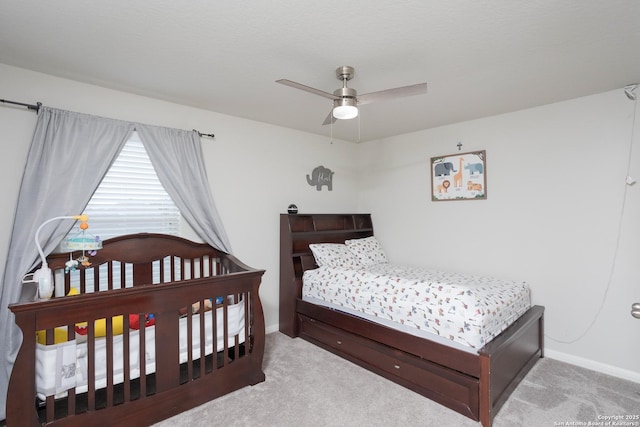 bedroom with ceiling fan and light colored carpet