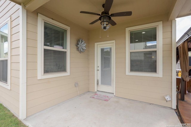 view of exterior entry featuring a patio and ceiling fan