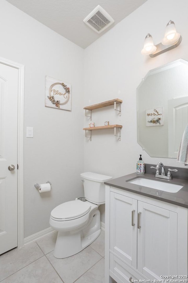 bathroom featuring tile patterned flooring, vanity, and toilet