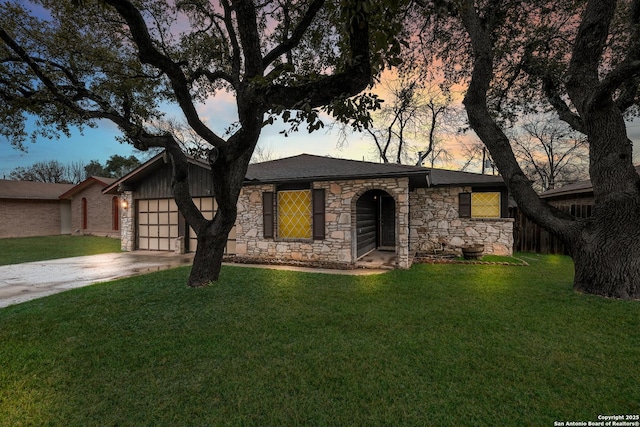 ranch-style home with a garage and a lawn