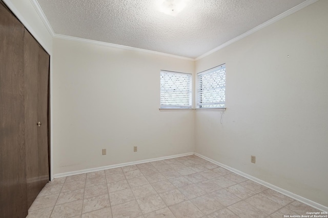 unfurnished room featuring crown molding and a textured ceiling