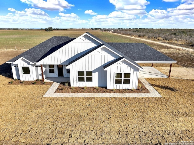 rear view of house with a rural view