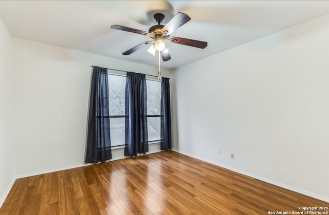 empty room featuring wood-type flooring and ceiling fan