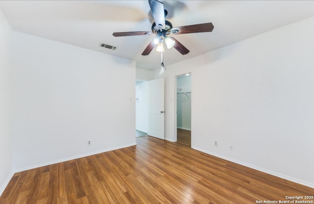 empty room featuring ceiling fan and hardwood / wood-style floors