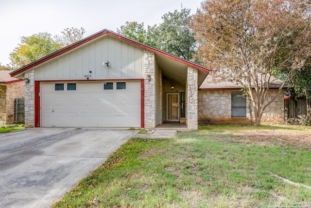 view of front of house with a garage and a front lawn